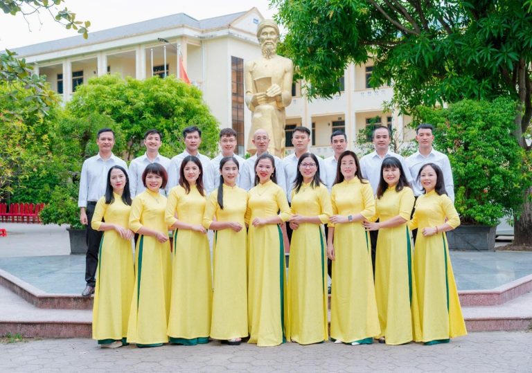 A group of people in yellow dresses Description automatically generated