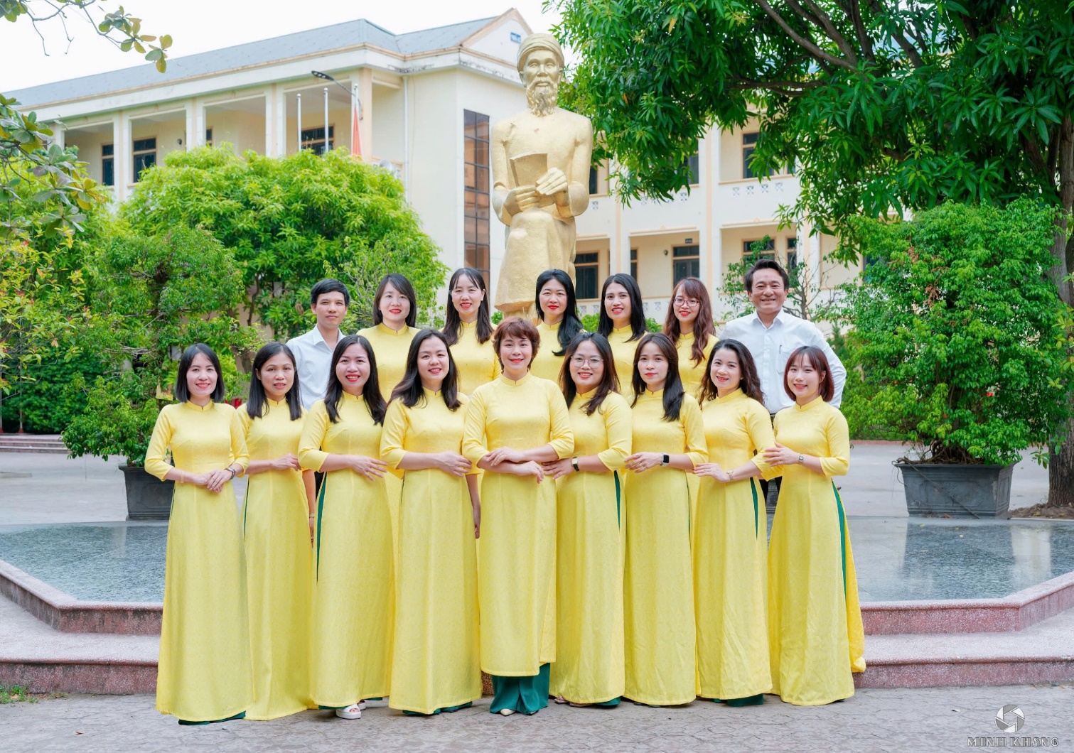 A group of people in yellow dresses

Description automatically generated