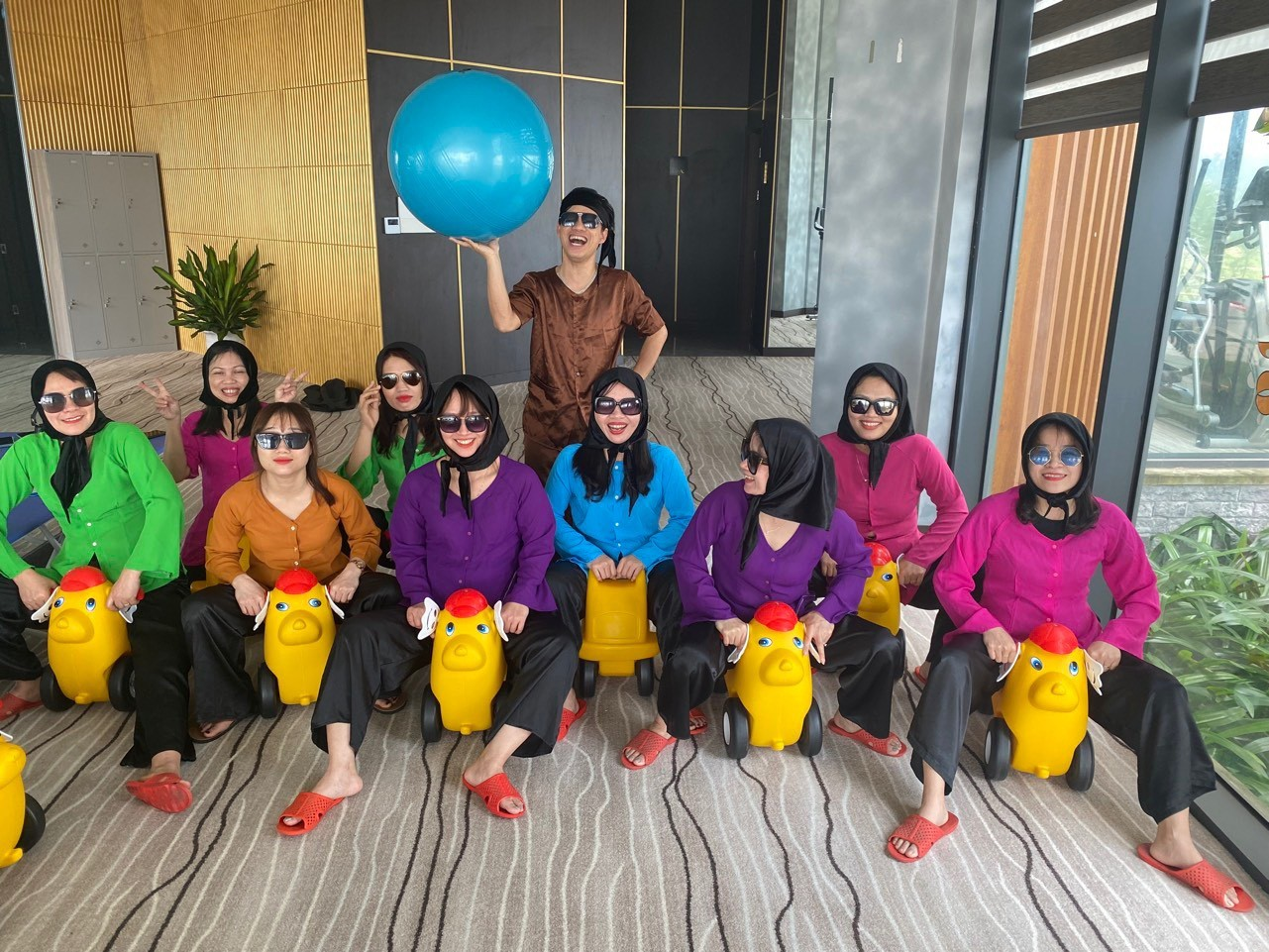 A group of women wearing colorful shirts and sunglasses

Description automatically generated