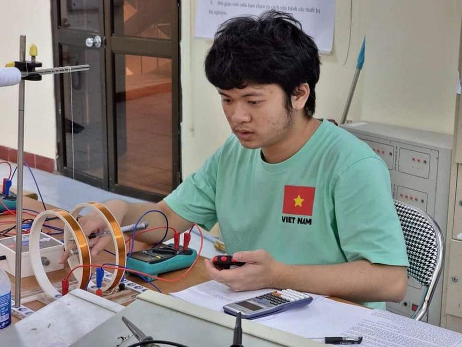 A person sitting at a desk with a device

Description automatically generated